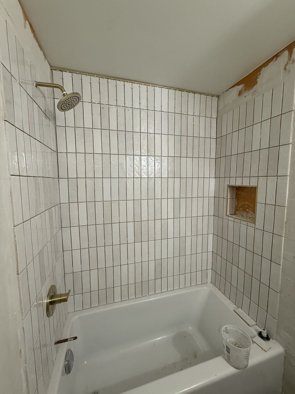 Tiled surround with gold fixtures